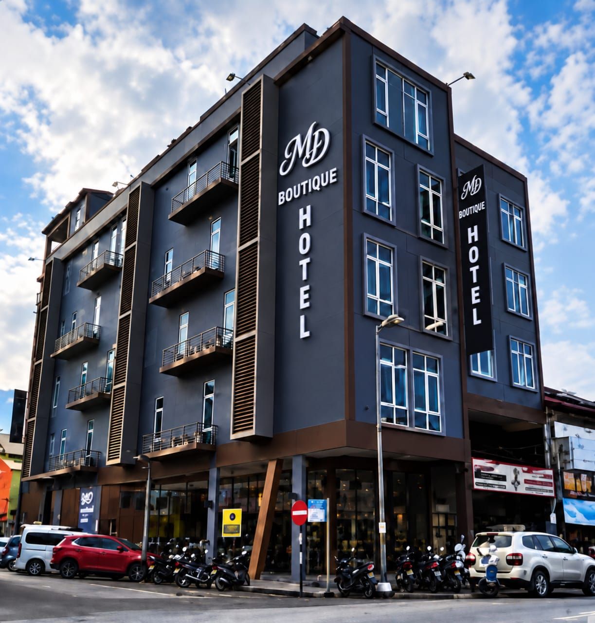 MD Boutique Hotel exterior in Kampar with bronze louvres and illuminated signage