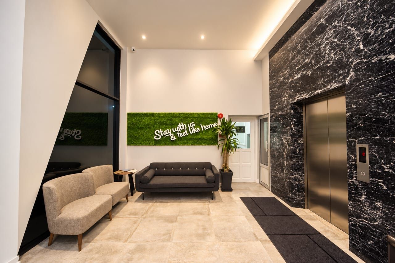 Lobby seating beside the marble lift wall